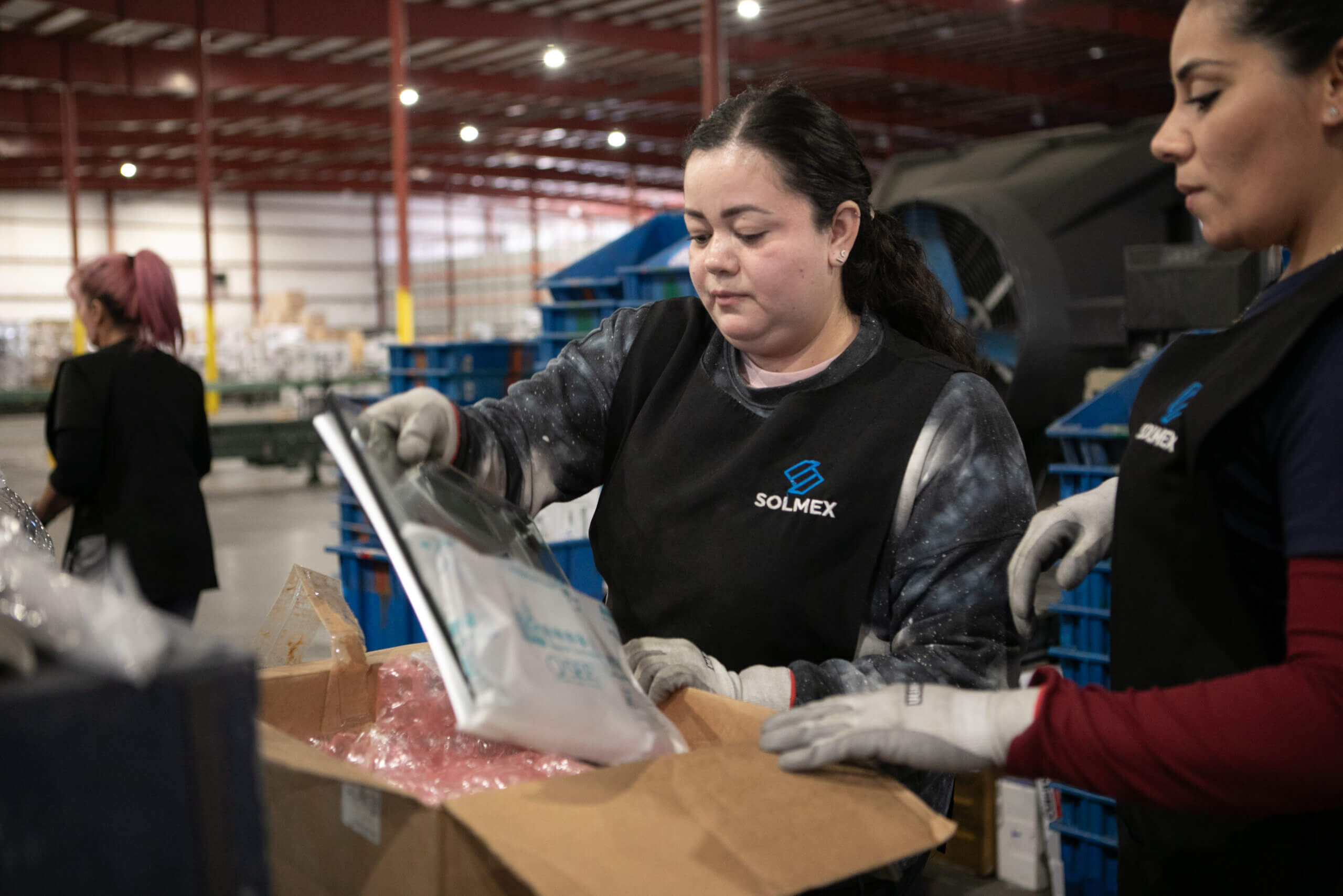 Two supply chain workers are fulfilling orders in a distribution warehouse