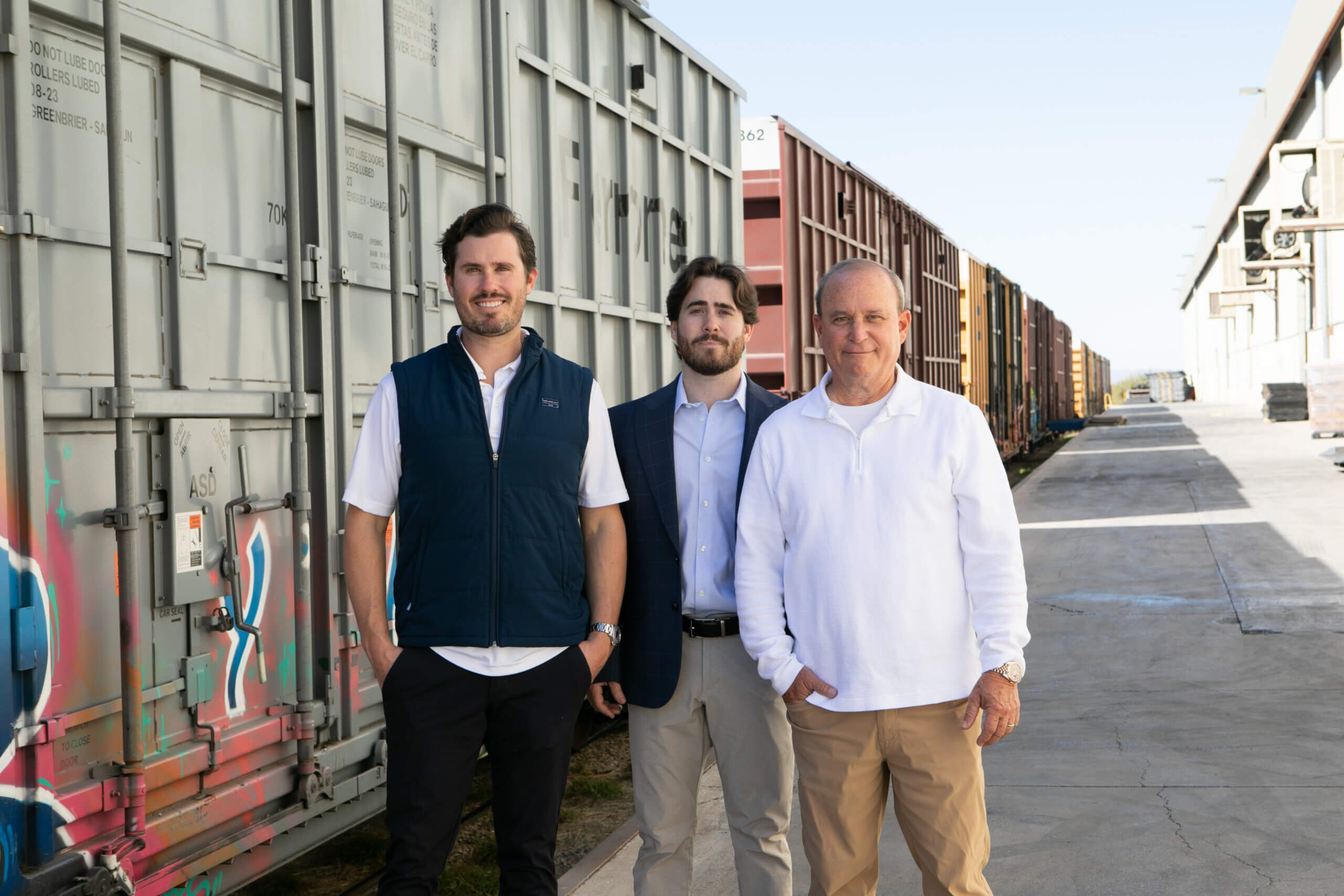 Three third-party logistics professionals touring outdoor storage facilities